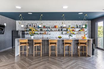a kitchen with a marble counter top and bar stools